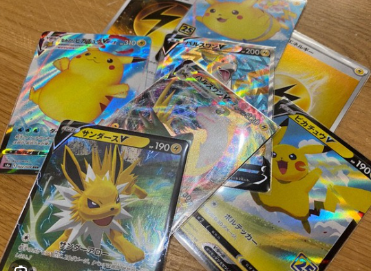 Holographic Pokémon cards arranged on a wooden tabletop